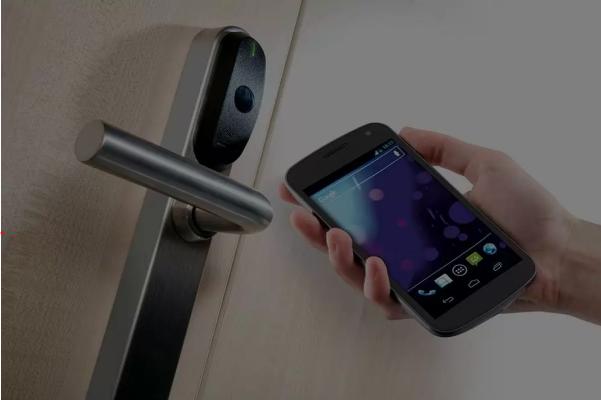 View of a mobile phone user opening a Paxton Paxlock Smart Locks for Business